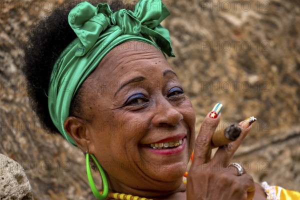 Old Cuban woman with green hair bow smokes a Havana cigar, Cuban woman with cigar and lacquered fingernails with the Cuban flag, Cuban flag, nail polish, La Habana, Cuba, Caribbean, Central America, Cuba, Europe, aerial view, birds-eyes view, aerial photography, aerial photography, overview, bird's eye view