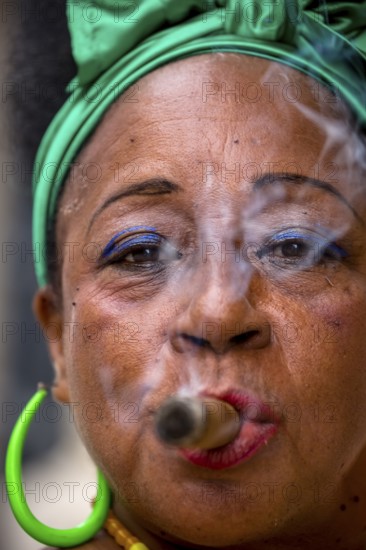 Old Cuban woman with green hair bow smokes a Havana cigar, Cuban woman with cigar and lacquered fingernails with the Cuban flag, Cuban flag, nail polish, La Habana, Cuba, Caribbean, Central America, Cuba, Europe, aerial view, birds-eyes view, aerial photography, aerial photography, overview, bird's eye view