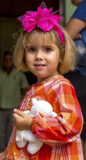 Little Cuban girl with white teddy bear and pink bow in her hair, Pink bow, Viñales, Cuba, Pinar del Río, Cuba, Viñales, Pinar del Río