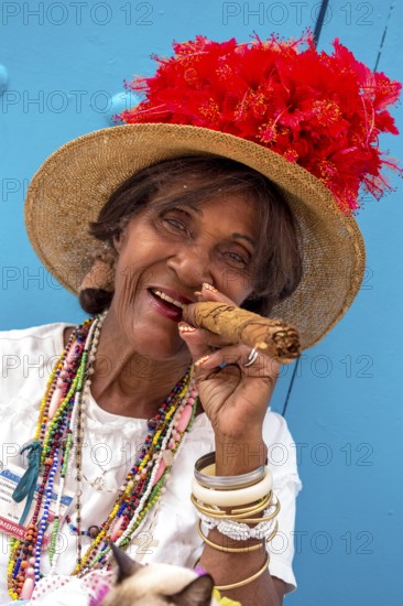 Old Cuban woman smokes a Cuban cigar on the street and posts with her cat for the tourists, La Habana, Cuba, Caribbean, Central America, Cuba, Europe, aerial photo, birds-eyes view, aerial photography, aerial photography, overview, bird's eye view