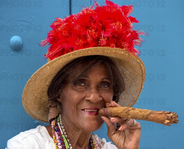 Old Cuban woman smokes a Cuban cigar on the street and posts with her cat for the tourists, La Habana, Cuba, Caribbean, Central America, Cuba, Europe, aerial photo, birds-eyes view, aerial photography, aerial photography, overview, bird's eye view