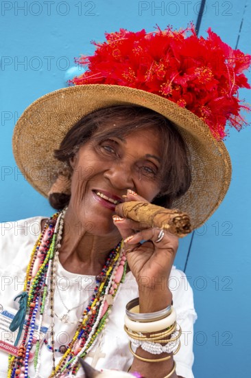 Old Cuban woman smokes a Cuban cigar on the street and posts with her cat for the tourists, La Habana, Cuba, Caribbean, Central America, Cuba, Europe, aerial photo, birds-eyes view, aerial photography, aerial photography, overview, bird's eye view