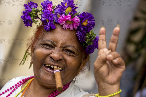 Peace sign, old Cuban woman with flowers and cigar posing for tourists for a tip, La Habana, Havana, Cuba, Cuba, Europe, aerial photo, birds-eyes view, aerial view, aerial photography, aerial photography, overview, bird's eye view