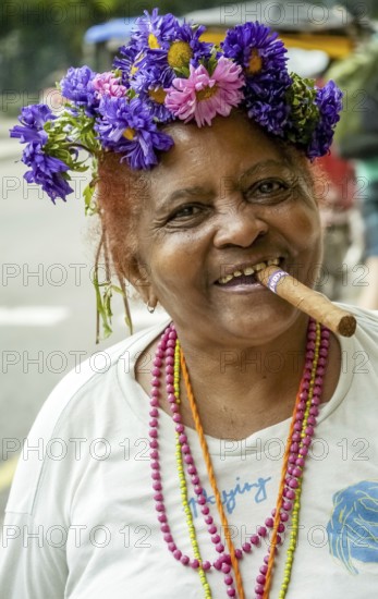 Old Cuban woman with flowers in her hair smoking a cigar and post for the photographer, La Habana, Havana, Cuba, Cuba, Europe, aerial view, birds-eyes view, aerial photography, aerial photography, overview, bird's eye view