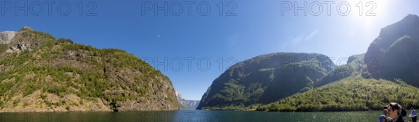 Fjord, Nærøyfjord, rock faces, mountains, blue sky, sunshine, Styvi, Sogn og Fjordane, Norway, Scandinavia, Europe, NOR, travel, tourism, destination, sightseeing, sea voyage, Hurtigruten, Hurtigruten trip, tourism, Norwegian, Scandinavian, tourist, cruise, adventure trip, waters, water, shipping, seafaring, sightseeing, hills, trees, forests, sky