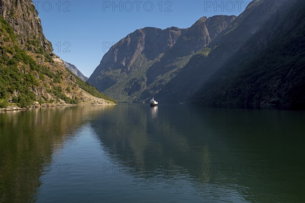 Excursion ship on a fjord, Flåm, Gudvangen, rock walls, trees, blue sky, Sogn og Fjordane, Norway, Scandinavia, Europe, NOR, travel, tourism, destination, sightseeing, sea voyage, Hurtigruten, Hurtigruten trip, tourism, Norwegian, Scandinavian, tourist, cruise, adventure trip, mountains, tourist trip, shipping, river, stones, tourist ship, water, waters
