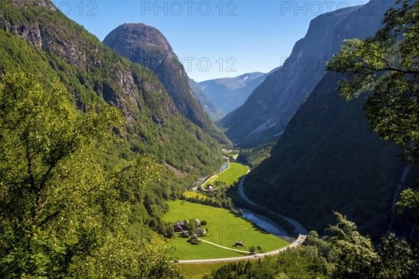 Valley, green meadows, path, rock faces, blue sky, Stalheim, Hordaland, Norway, Scandinavia, Europe, NOR, travel, tourism, destination, sightseeing, sea voyage, Hurtigruten, Hurtigruten trip, tourism, Norwegian, Scandinavian, tourist, cruise, adventure trip, landscape, mountains, road, houses, sky