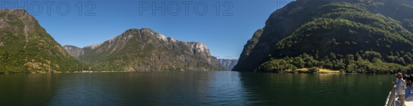 Fjord, Nærøyfjord, rock faces, mountains, blue sky, Styvi, Sogn og Fjordane, Norway, Scandinavia, Europe, NOR, travel, tourism, destination, sightseeing, sea voyage, Hurtigruten, Hurtigruten voyage, tourism, Norwegian, Scandinavian, tourist, cruise, adventure trip, hills, trees, forests, sky, rocks
