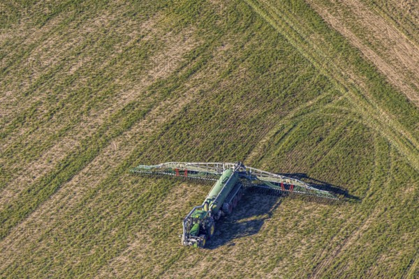 Aerial view, Tractor and agricultural spraying machine on a field, Paradiese, Soest, Soester Börde, North Rhine-Westphalia, Germany, DE, Europe, agriculture, aerial view, aerial photography, aerial photography, sprayer, tractor, overview, bird's-eye view, meadows and fields, birds-eyes view, overview