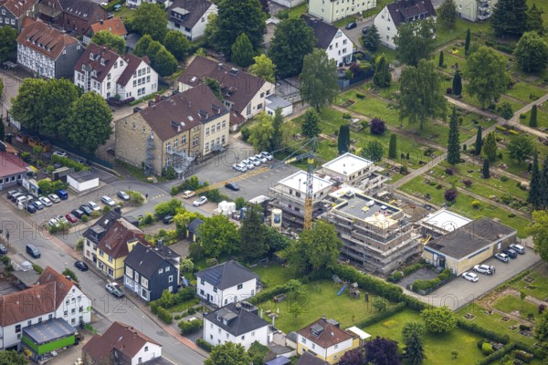 Aerial view, construction site with new building on the main road at the cemetery, left Städt. Kita und Familienzentrum KiFaz, Niedersprockhövel, Sprockhövel, Ruhr area, North Rhine-Westphalia, Germany, construction work, construction area, building site, building plots, construction project, construction site, DE, Europe, kindergarten, day-care centre, day-care centre for children, aerial photograph, aerial photography, aerial photography, new building, overview, bird's-eye view, overview