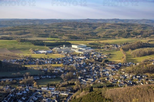 Aerial view, town centre Stockum (Sauerland) with catholic St. Pankratius church, heritage-protected church building, Tillmann Wellpappe-Verpackungen factory premises, commercial area, hilly landscape with forest and distant view, Stockum, Sundern, Sauerland, North Rhine-Westphalia, Germany, DE, Europe, commercial enterprises, commercial area, commercial property, commercial location, commercial use, industrial area, industrial location, aerial photograph, aerial photography, aerial photography, overview, bird's-eye view, overview