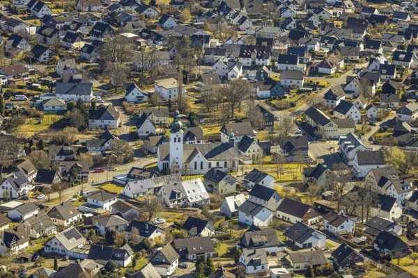 Aerial view, residential area and Roman Catholic parish church St. Kunibertus in the town centre, Hünsborn, Wenden, Sauerland, North Rhine-Westphalia, Germany, place of worship, DE, monument protection, Europe, religious community, place of worship, property tax, holy site, real estate, church, parish, denomination, aerial view, aerial photography, aerial photography, religion, religious site, overview, bird's-eye view, residential area, living and life, residential area, residential quality, residential quarter, housing estate, residential district, birds-eyes view, overview