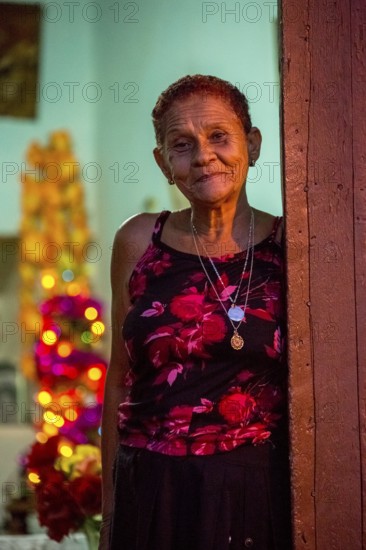 Old lady looks friendly out of her front door, Street scene in the old town of Trinidad, Trinidad, Cuba, Sancti Spíritus, Cuba, Sancti Spíritus