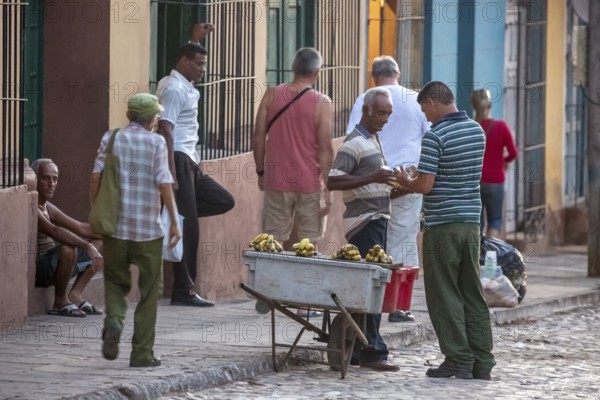 Banana vendor with his stall on the street, Street scene in the old town of Trinidad, Trinidad, Cuba, Sancti Spíritus, Cuba, Sancti Spíritus