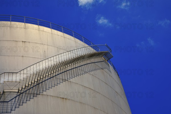 A staircase runs along a large tank in front of a deep blue sky, elevated tank, chemical, company, Grenzach- Wyhlen, Baden-Württemberg, Germany