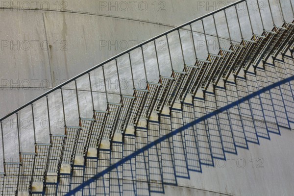 Close-up of a metal staircase with detailed shadows on the tank surface, elevated tank, chemical, company, Grenzach- Wyhlen, Baden-Württemberg, Germany