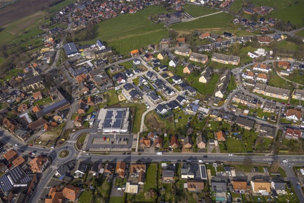 Aerial view, residential area local view district Dolberg, new REWE supermarket with solar roof, wind turbines, new roundabout Alleestraße and Uentroper Straße, new residential area Hases Wiese, catholic St. Lambertus church, Ahlen, Dolberg, Ruhr area, Germany, residential area, local view, district, REWE supermarket, solar roof, roundabout, Alleestraße, Uentroper Straße, new construction, Hases Wiese, catholic, St. Lambertus Church, architecture, urban planning, infrastructure, energy, sustainable, traffic, urbanisation, church, retail, solar system, renewable energy, district, streets, residential buildings, shops, community, landscape, development, environmentally friendly