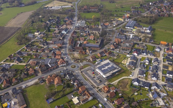 Aerial view, residential area local view district Dolberg, new REWE supermarket with solar roof, wind turbines, new roundabout Alleestraße and Uentroper Straße, new residential area Hases Wiese, catholic St. Lambertus church, Ahlen, Dolberg, Ruhr area, Germany, residential area, local view, district, REWE supermarket, solar roof, roundabout, Alleestraße, Uentroper Straße, new construction, Hases Wiese, catholic, St. Lambertus Church, urban, development, infrastructure, energy, renewable energy, traffic, roads, architecture, flats, churches, supermarkets, sustainability, modern, urban planning, community, panorama, daylight