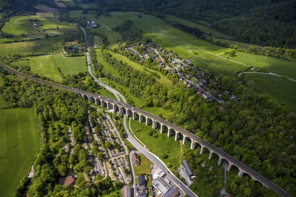 Aerial view, Altenbekener Viaduct, Adenauerstraße, railway viaduct Bridge structure, also called Bekeviaduct or Great Viaduct, suburban railway, Altenbeken cemetery and cross chapel on the Alter Kirchweg road, residential area Am Stapelsberg, meadows and fields, Altenbeken, East Westphalia, North Rhine-Westphalia, Germany, railway viaduct, bridge construction, Beke Viaduct, Great Viaduct, Altenbeken Cemetery, Cross Chapel, Alter Kirchweg road, meadows, fields, infrastructure, traffic, landscape, rural, architecture, train, railway, cemetery, chapel, residential area, agricultural landscape, hill, nature, building, railway, urban, village, town, green, field work, rural scene
