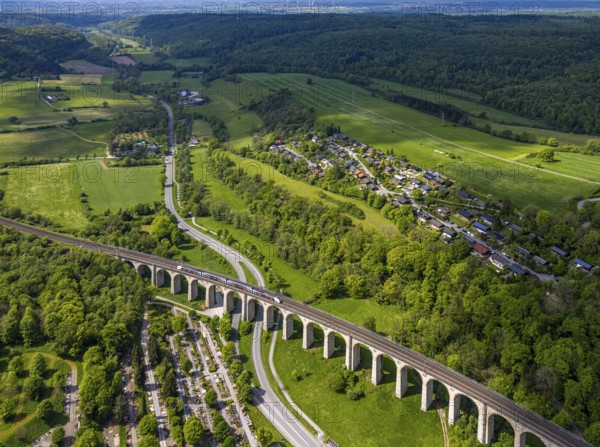 Aerial view, Altenbekener Viaduct, Adenauerstraße, railway viaduct bridge construction, also called Bekeviaduct or Great Viaduct, suburban railway, Altenbeken cemetery on the Alter Kirchweg road, residential area Am Stapelsberg, meadows and fields, Altenbeken, East Westphalia, North Rhine-Westphalia, Germany, railway viaduct, bridge construction, Bekeviaduct, Great Viaduct, Altenbeken cemetery, Alter Kirchweg, residential area, Am Stapelsberg, meadows, fields, traffic, infrastructure, railway, train, landscape, rural, architecture, building, history, transport, green spaces, nature, urbanisation, residential, cemetery, agricultural, aerial view, perspective