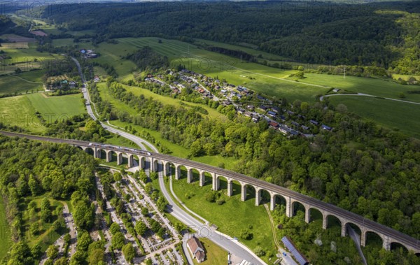 Aerial view, Altenbekener Viaduct, Adenauerstraße, railway viaduct Bridge structure, also called Bekeviaduct or Great Viaduct, suburban railway, Altenbeken cemetery and cross chapel on the Alter Kirchweg road, residential area Am Stapelsberg, meadows and fields, East Westphalia, Altenbeken, North Rhine-Westphalia, Germany, railway viaduct, bridge construction, Beke viaduct, Great viaduct, Altenbeken cemetery, cross chapel, Alter Kirchweg, meadows, fields, architecture, traffic, infrastructure, landscape, urban, rural, railway, rails, train traffic, cultural monument, historical, nature, green spaces, residential, road, transport, travel, sight, perspective, panorama