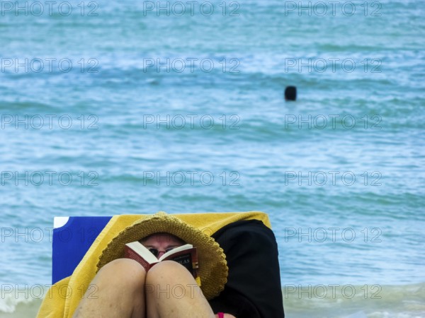 Sunbathing on loungers, reading on holiday, Varadero, Cuba, Matanzas, Cuba, Central America