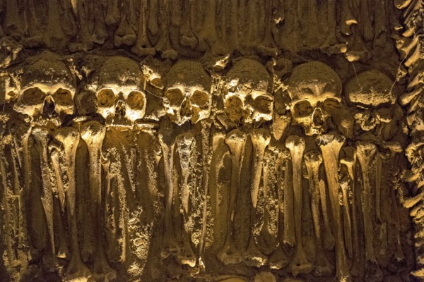 Piled bones in the ossuary, Capela dos ossos parede, chapel of bones, bone chapel, ossuary in Évora, Evora, district of Évora, Portugal