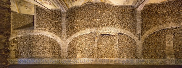 Piled bones in the ossuary, Capela dos ossos parede, chapel of bones, bone chapel, ossuary in Évora, Evora, district of Évora, Portugal