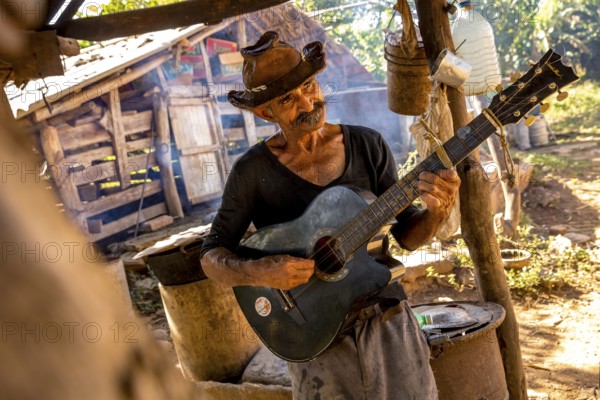 Sugar cane farmer in Valle de los Ingenios plays guitar for the tourists, Trinidad, Cuba, Sancti Spíritus, Cuba, Sancti Spíritus
