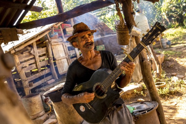 Sugar cane farmer in Valle de los Ingenios plays guitar for the tourists, Trinidad, Cuba, Sancti Spíritus, Cuba, Sancti Spíritus