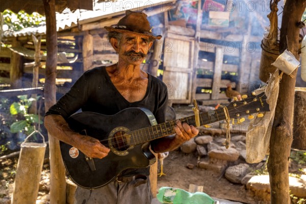 Sugar cane farmer in Valle de los Ingenios plays guitar for the tourists, Trinidad, Cuba, Sancti Spíritus, Cuba, Sancti Spíritus