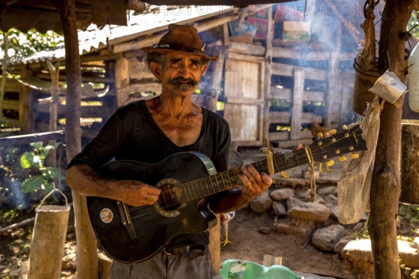 Sugar cane farmer in Valle de los Ingenios plays guitar for the tourists, Trinidad, Cuba, Sancti Spíritus, Cuba, Sancti Spíritus