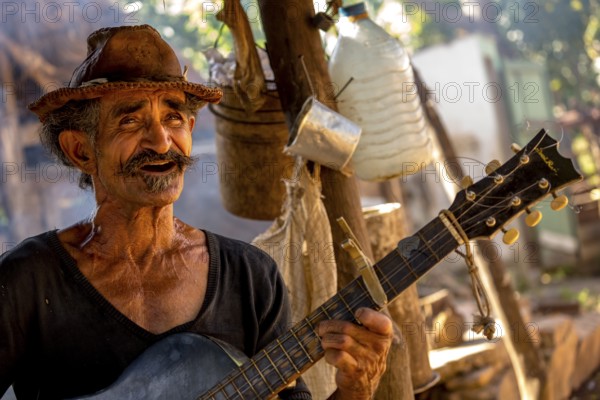 Sugar cane farmer in Valle de los Ingenios plays guitar for the tourists, Trinidad, Cuba, Sancti Spíritus, Cuba, Sancti Spíritus