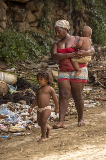 Mother with two children barefoot at a rubbish dump, poverty on the island of Cuba, Trinidad, Cuba, Sancti Spíritus, Cuba, Sancti Spíritus