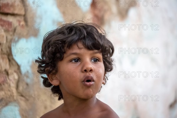 Little Cuban boy on the street in front of an old wall, Street scene in the old town of Trinidad, Trinidad, Cuba, Sancti Spíritus, Cuba, Sancti Spíritus