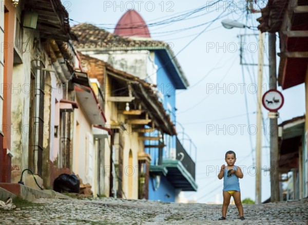 Little boy with nappies standing on the street, street scene in the old town of Trinidad, Trinidad, Cuba, Sancti Spíritus, Cuba, Sancti Spíritus