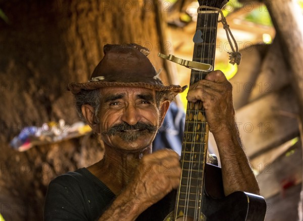Sugar cane farmer in Valle de los Ingenios plays guitar for the tourists, Trinidad, Cuba, Sancti Spíritus, Cuba, Sancti Spíritus