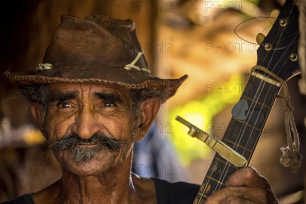 Sugar cane farmer in Valle de los Ingenios plays guitar for the tourists, Trinidad, Cuba, Sancti Spíritus, Cuba, Sancti Spíritus