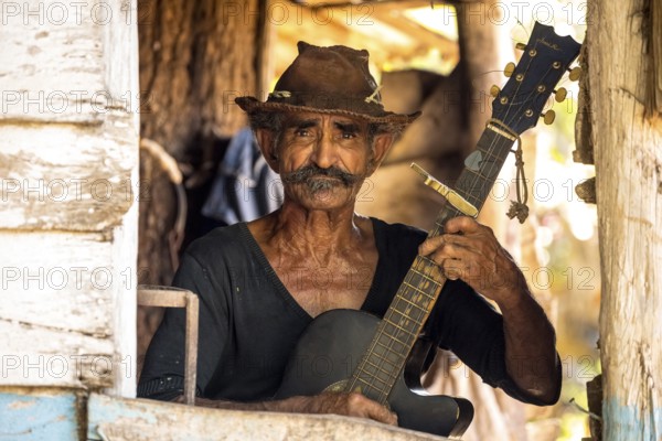 Sugar cane farmer in Valle de los Ingenios plays guitar for the tourists, Trinidad, Cuba, Sancti Spíritus, Cuba, Sancti Spíritus