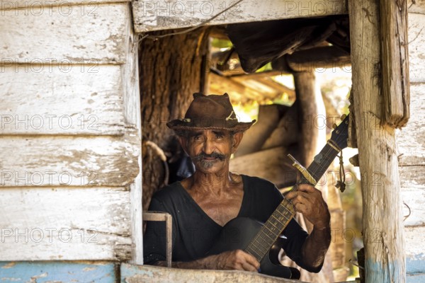 Sugar cane farmer in Valle de los Ingenios plays guitar for the tourists, Trinidad, Cuba, Sancti Spíritus, Cuba, Sancti Spíritus