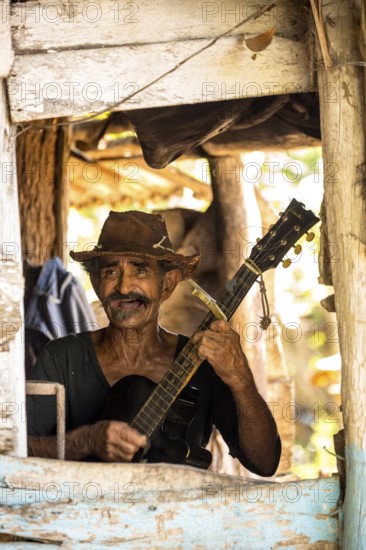 Sugar cane farmer in Valle de los Ingenios plays guitar for the tourists, Trinidad, Cuba, Sancti Spíritus, Cuba, Sancti Spíritus