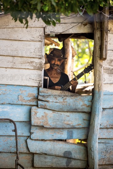 Sugar cane farmer in Valle de los Ingenios plays guitar for the tourists, Trinidad, Cuba, Sancti Spíritus, Cuba, Sancti Spíritus