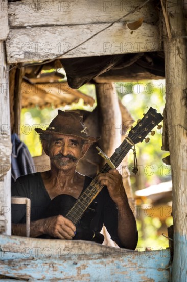 Sugar cane farmer in Valle de los Ingenios plays guitar for the tourists, Trinidad, Cuba, Sancti Spíritus, Cuba, Sancti Spíritus