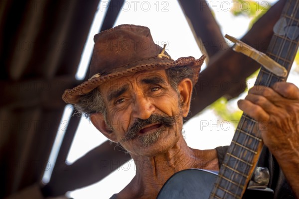 Sugar cane farmer in Valle de los Ingenios plays guitar for the tourists, Trinidad, Cuba, Sancti Spíritus, Cuba, Sancti Spíritus