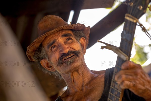 Sugar cane farmer in Valle de los Ingenios plays guitar for the tourists, Trinidad, Cuba, Sancti Spíritus, Cuba, Sancti Spíritus
