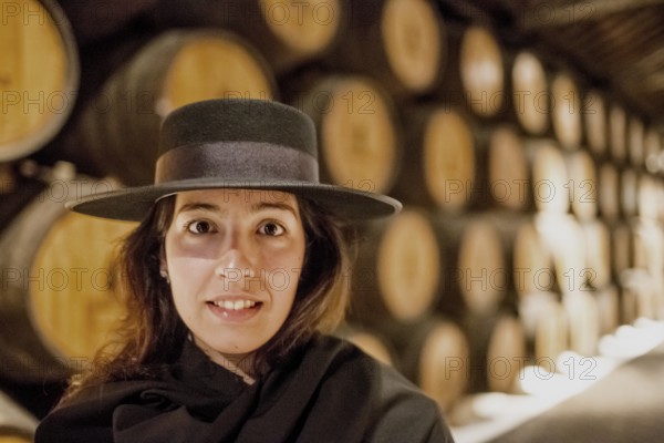 Classic travel guide with student robe, zorro hat and cape, port wine barrels, wine cellar of the Sandemann winery in Gaia, Porto, Vila Nova de Gaia, Porto district, Portugal, Europe, aerial view, birds-eyes view, Travel, travel photography