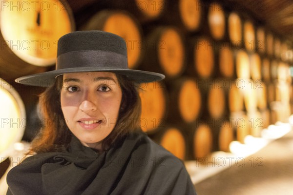 Classic travel guide with student robe, zorro hat and cape, port wine barrels, wine cellar of the Sandemann winery in Gaia, Porto, Vila Nova de Gaia, Porto district, Portugal, Europe, aerial view, birds-eyes view, Travel, travel photography
