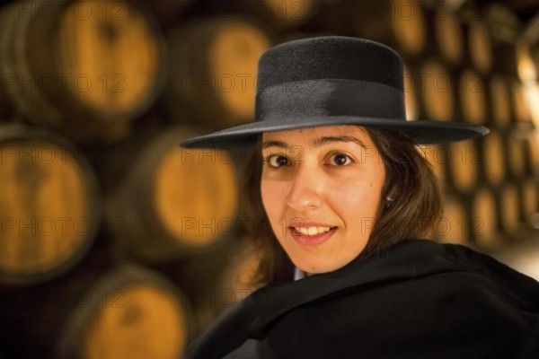 Classic travel guide with student robe, zorro hat and cape, port wine barrels, wine cellar of the Sandemann winery in Gaia, Porto, Vila Nova de Gaia, Porto district, Portugal, Europe, aerial view, birds-eyes view, Travel, travel photography