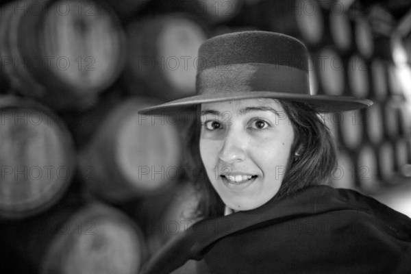 Classic travel guide with student robe, zorro hat and cape, port wine barrels, wine cellar of the Sandemann winery in Gaia, Porto, Vila Nova de Gaia, Porto district, Portugal, Europe, aerial view, birds-eyes view, Travel, travel photography