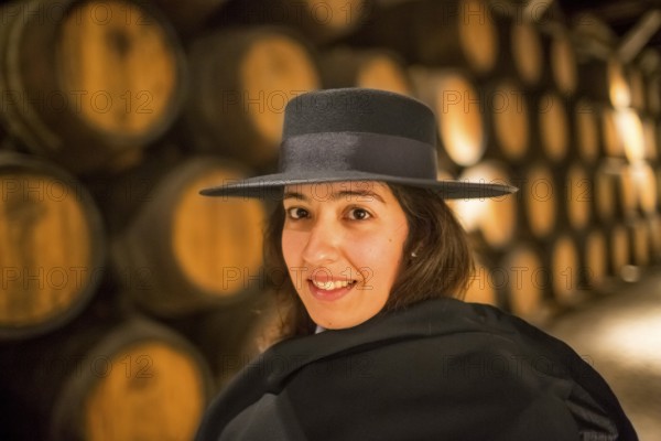 Classic travel guide with student robe, zorro hat and cape, port wine barrels, wine cellar of the Sandemann winery in Gaia, Porto, Vila Nova de Gaia, Porto district, Portugal, Europe, aerial view, birds-eyes view, Travel, travel photography
